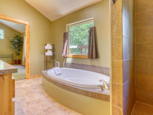 a large bathroom with a tub and a shower at Salmon River Chalet - Meredith Lodging in Welches