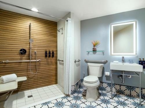 a bathroom with a toilet and a shower and a sink at The Maya in Long Beach