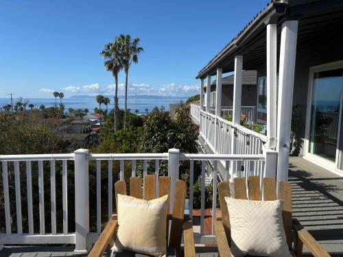 two chairs sitting on a porch with a view of the ocean at Casa Pacifica in San Pedro