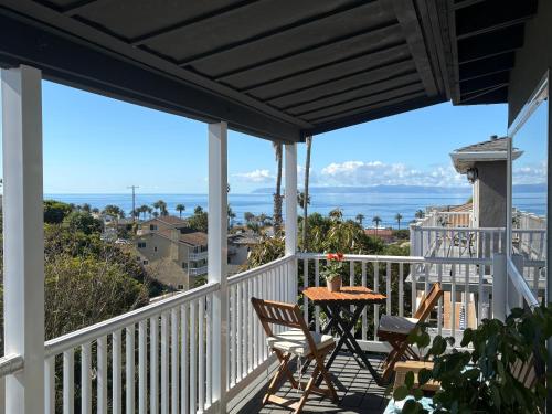 a balcony with a table and chairs and the ocean at Casa Pacifica in San Pedro