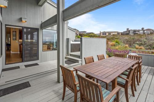 a wooden table and chairs on a deck at Eagle's Nest in Bodega Bay