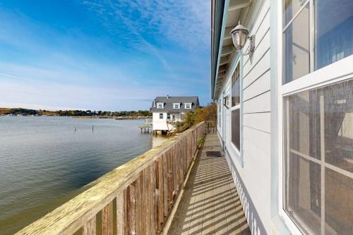 a balcony of a house with a view of the water at Bayside Cottage in Bodega Bay