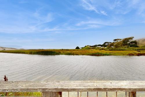 a person standing next to a body of water at Mar-Tiny in Bodega Bay