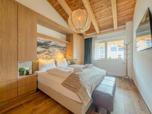 a bedroom with a large bed with a painting on the wall at Birdie Lodge in Sankt Lambrecht