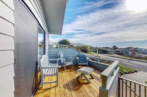 a balcony with chairs and a view of a street at Pinnacle Heights in Bodega Bay