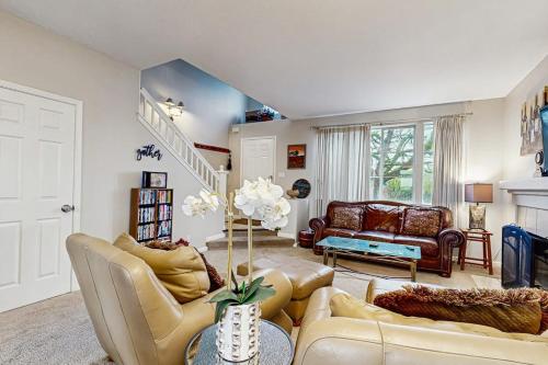 a living room with couches and a staircase at The Grape Escape in Santa Rosa