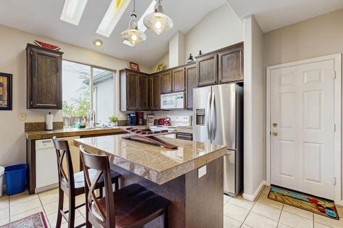a kitchen with a counter and a refrigerator at The Grape Escape in Santa Rosa