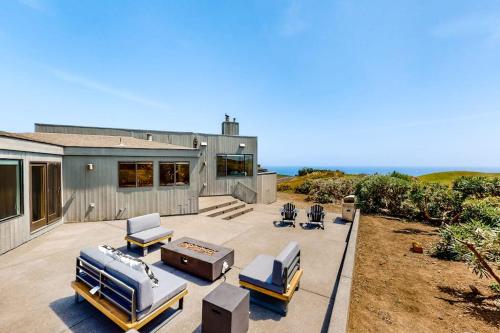 a house with a patio with two beds and a grill at Latitude 38 in Bodega Bay