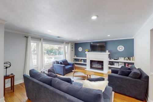 a living room with two couches and a fireplace at James House in Santa Rosa