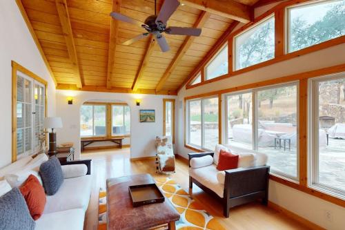 a living room with a ceiling fan and windows at Warm Springs Paradise in Glen Ellen