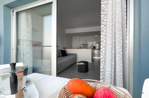 a living room with a bowl of fruit on a table at 51 E-scape Home in Corralejo