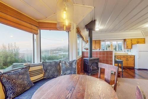 a dining room with a table and a stove at Seaside Cottage in Bodega Bay