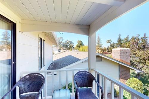 two chairs on a porch with a view of a house at Silverado Resort and Spa 266 & 267 in Napa