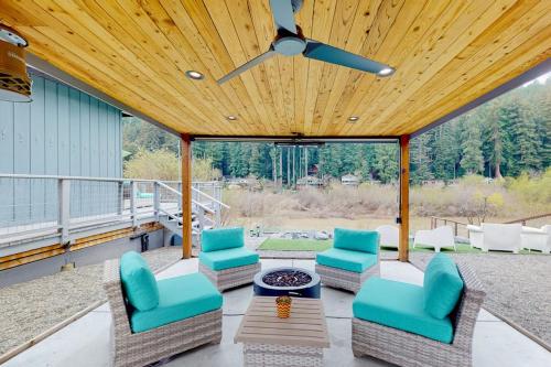 a patio with chairs and a table and a ceiling at Riverfront Escape in Monte Rio