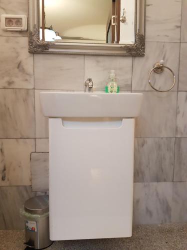 a bathroom with a white sink and a mirror at Bucharest Boutique Accommodation by Hotels in Bucharest