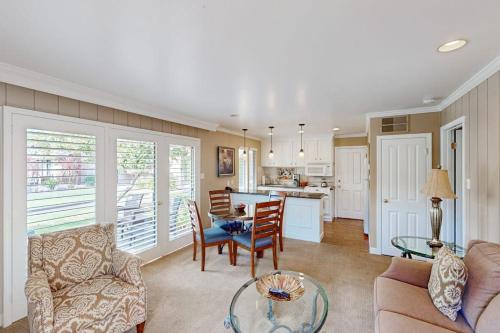 a living room with a table and chairs and a kitchen at Silverado Resort and Spa 287 & 288 in Napa