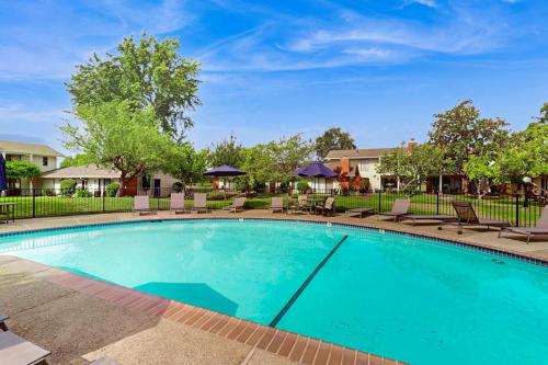 a large swimming pool with chairs and umbrellas at Silverado Resort and Spa 287 & 288 in Napa