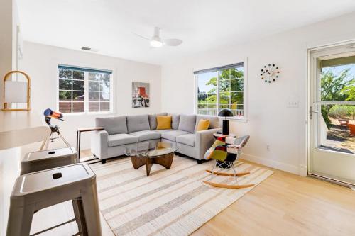 a living room with a couch and a table at Bird and Barrel Vineyard Farmhouse in Healdsburg