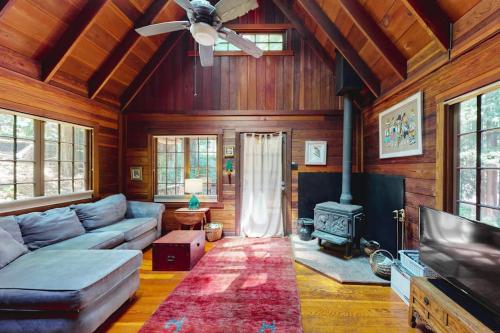 a living room with a couch and a fireplace at Dreamcatcher Cottage in Cazadero