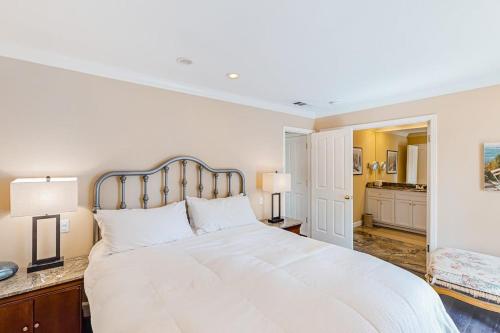 a bedroom with a large white bed and a kitchen at Silverado Resort and Spa 381 in Napa