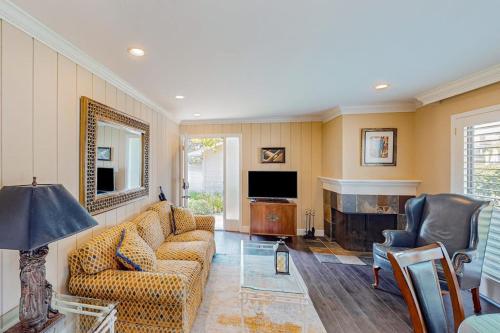 a living room with a couch and a television at Silverado Resort and Spa 381 & 382 in Napa