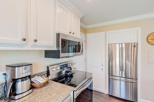 a kitchen with white cabinets and a stainless steel refrigerator at Silverado Resort and Spa 381 & 382 in Napa