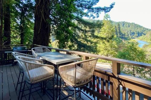 a table and chairs on a deck with a view at Monte Rio Vista Lodge in Monte Rio