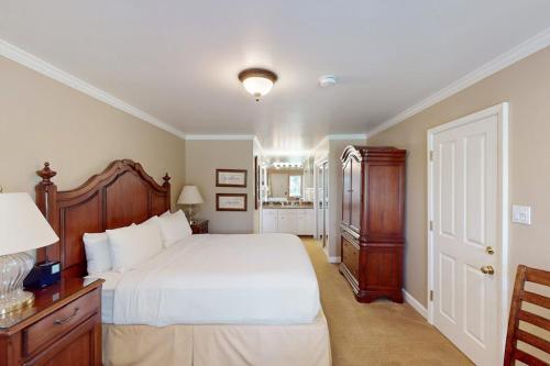 a bedroom with a large bed with a wooden headboard at Silverado Resort and Spa 288 in Napa