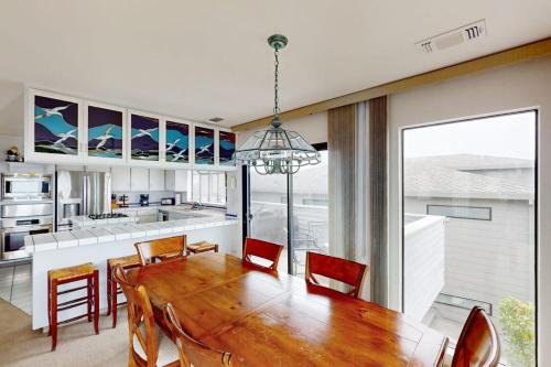 a kitchen and dining room with a wooden table and chairs at Sea Way Dreams in Bodega Bay