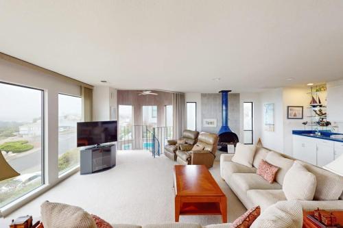 a living room with a couch and a tv at Sea Way Dreams in Bodega Bay