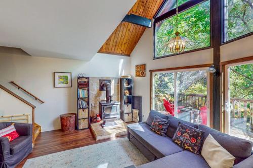 a living room with a couch and a fireplace at Cazadero Dreams in Cazadero