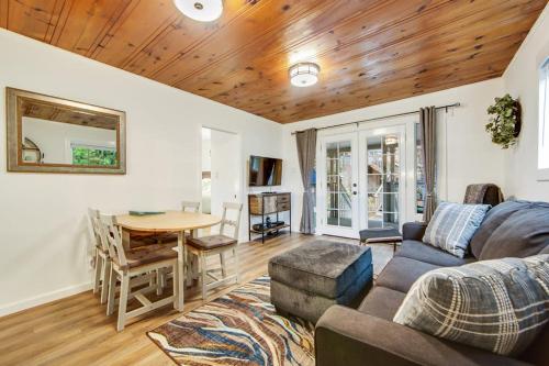 a living room with a couch and a table at Wanderlust Cottage in Guerneville