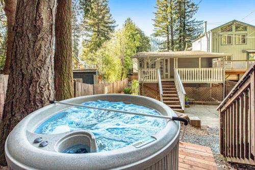 a hot tub in a yard next to a tree at Wanderlust Cottage in Guerneville
