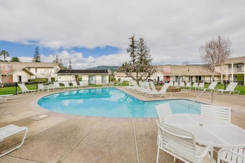 a swimming pool with white chairs and a table at Silverado Resort and Spa 353 in Napa