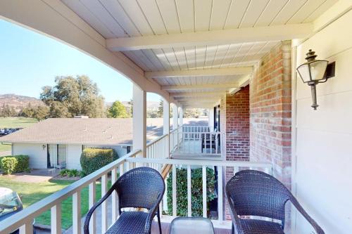 a porch with two chairs and a house at Silverado Resort and Spa 266 in Napa