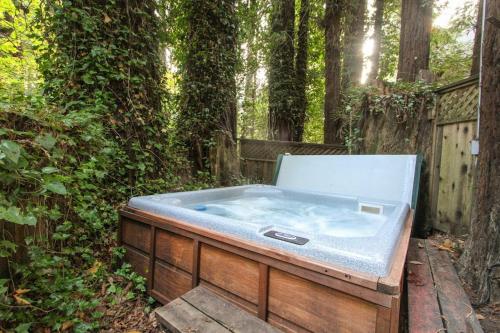 a hot tub sitting in the middle of a garden at Clearheart Grove in Guerneville
