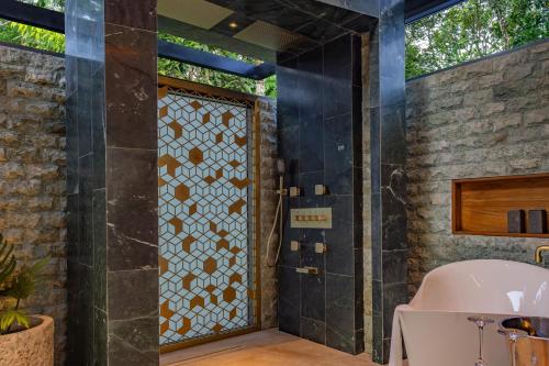 a bathroom with a shower with a glass door at Noah's Hideaway by Tifakara in Fortuna