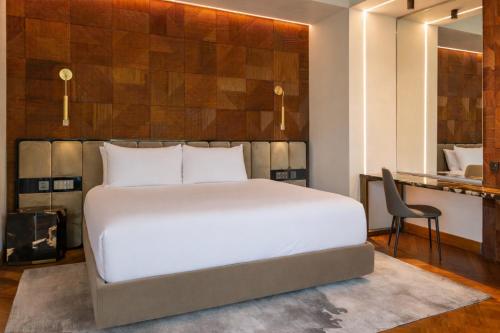 a bedroom with a large white bed and a desk at Noah's Hideaway by Tifakara in Fortuna