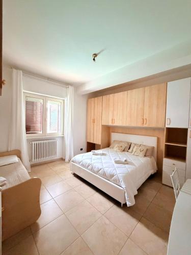 a bedroom with a large white bed in it at Villa Martila in Bari