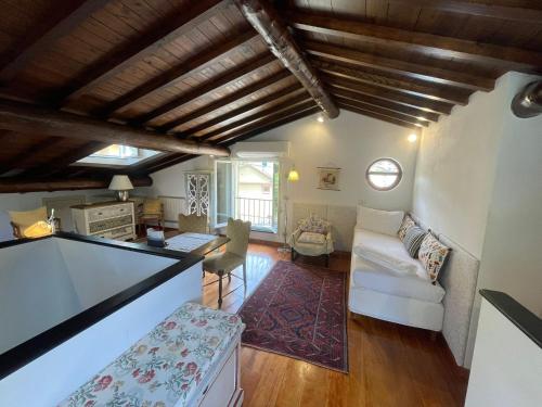a living room with a white couch and a table at Mansarda Portofino in Portofino