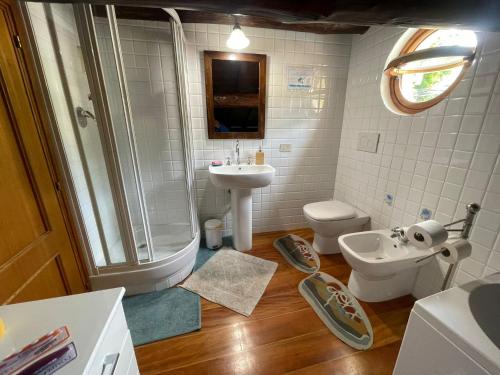 a bathroom with a shower and a sink and a toilet at Mansarda Portofino in Portofino