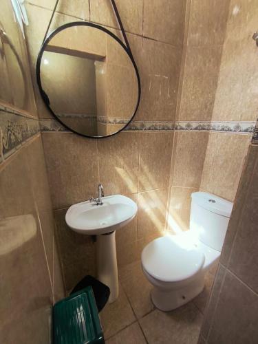 a bathroom with a toilet and a sink and a mirror at Studio premium -- ap 06 in Diadema