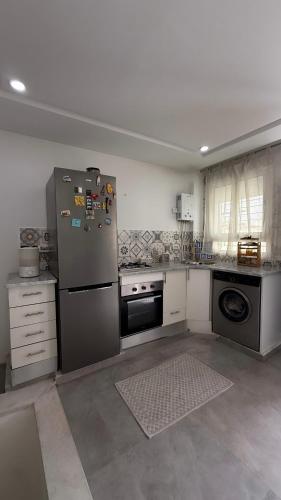 a kitchen with a stainless steel refrigerator and a dishwasher at Sidi bou duplex in La Goulette