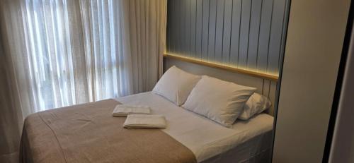 a bedroom with a bed with two towels on it at Vg Sun Cumbuco Beach House in Caucaia