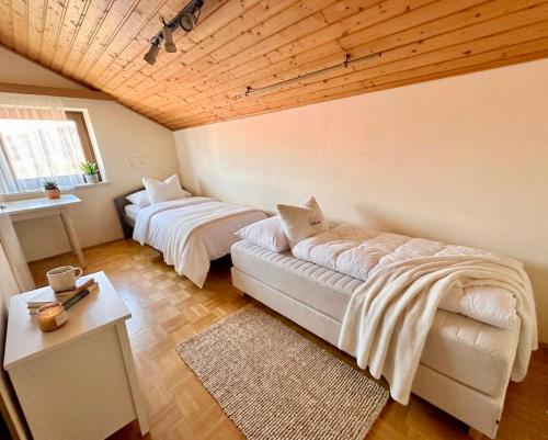 a room with two beds and a couch in it at Apartment Karawankenblick with Lake View - Free Parking in Pörtschach am Wörthersee