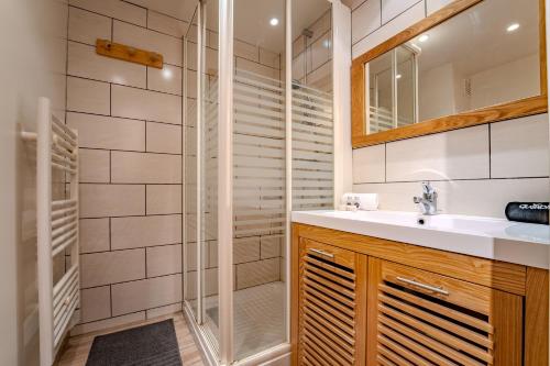 a bathroom with a sink and a shower at Mountain View with Ski-In and Out Loft - Résidence Roche Blanche in Val Thorens