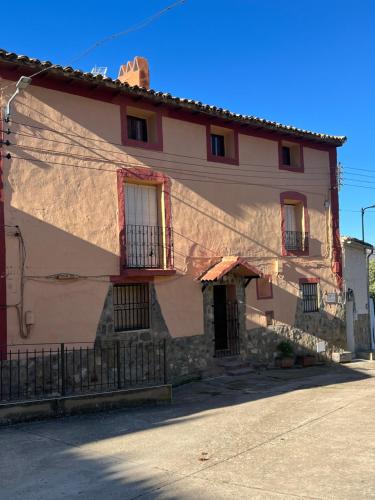 a building with a large shadow on the side of it at La Casonna - Aluenda in El Frasno