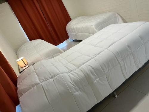 a bed and a chair in a room at Hotel La Morada in Treinta y Tres