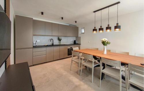 a large kitchen with a wooden table and chairs at Holiday Home Grljevacka Vi in Podstrana