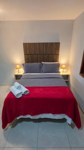a bedroom with a large bed with two towels on it at Flats Marina do Sol in Florianópolis